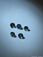 Five round blue-green sapphires face-up
