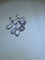 Group of nine lavender tanzanite ovals on neutral background