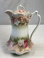 Full view of porcelain chocolate pot showing floral design and form