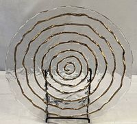 Front view of clear textured glass platter showing gold spiral design