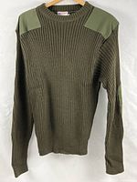 Front view of olive drab ribbed wool sweater with canvas shoulder patches