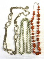 Three necklaces laid side by side showing full length and styles
