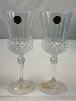 Two matching crystal goblets standing side by side