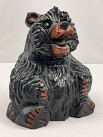 front view carved black wood bear with marble eyes