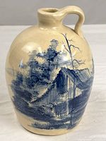 Front view showing hand-painted landscape on jug