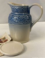 Pitcher standing beside coaster and paperwork