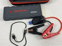 Jump starter, clamps, USB cable displayed together
