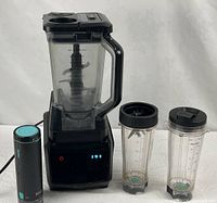 Entire blender system with base, pitcher, FreshVac pump, two cups, blade and lid visible