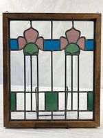 Front view of full stained glass panel within wood frame