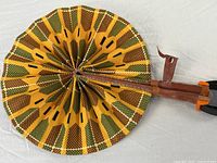 Fan fully opened showing full geometric wax print pattern