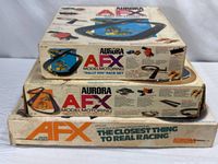Stacked view of three Aurora AFX race set boxes