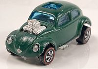 Front and left side view showing chrome engine, wheels, paint wear