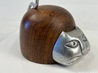 Front view showing teak body and metal face