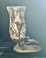 Full view of lamp front showing frog figures, base and hurricane glass shade
