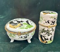 Front view of both trinket boxes showing shapes, motifs and metal clasps
