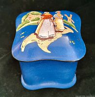 Closed blue porcelain trinket box showing Dutch scene on lid