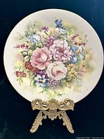 Front view of floral decorative plate on stand