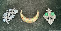 Front view of all three brooches