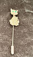 Front view of cat stick pin showing design and rhinestone eyes