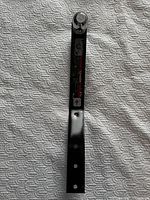 Full view of the hitch showing overall length, black finish, chrome ball