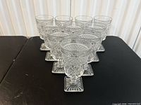 Front view of all 10 Cape Cod water goblets arranged in rows