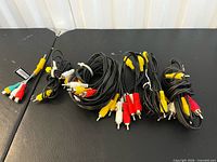 Group of six black RCA composite cables with yellow red white connectors
