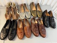 All seven pairs of shoes laid out on table