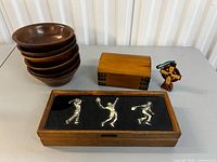 Group shot showing all items: bowls stacked, trinket box, cross, framed figures