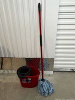 Full view of bucket with wringer and assembled mop