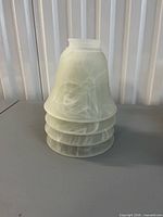 Stacked view of four frosted glass light shades showing swirl pattern and ribbed lower section