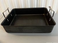 Overall view of rectangular roaster showing interior and handles