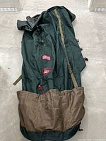 Full view of green and brown upright tree storage bag laid out