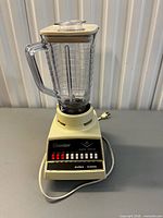 Full view of assembled Osterizer blender showing base, control panel, jar, lid, and cord