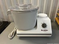 Front angled view of mixer showing base, bowl, lid, dial, cord