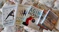 Group shot of three books and three DVDs on quilt