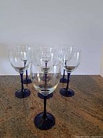 Front view of all seven wine glasses showing design and quantity
