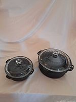 Both Wagner cast iron casseroles with lids displayed side by side