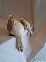 Front angled view of both ceramic duck figurines