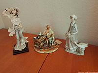 All three porcelain figurines grouped together for size and overall condition reference