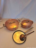 Group shot of all four copper cookware pieces