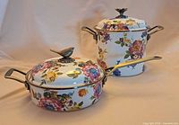 Two MacKenzie-Childs floral enamel cookware pieces with lids