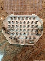 Open case showing multiple stainless steel tips in molded holder