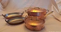 Group shot of casserole, poaching pan with lid, two gratin dishes