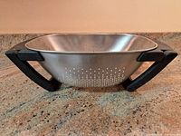 Side view showing stainless bowl and black adjustable handles