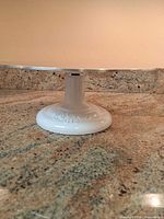 Side view of assembled cake stand showing base and top