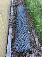 Full view of rolled chain-link fence outdoors