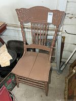 full view of brown painted press back chair