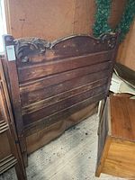 Front view of entire headboard showing size, design and wear