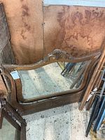 Front view of oak mirror showing carved crest and full glass