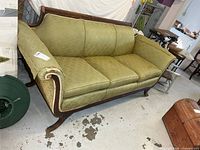 Front left view showing wood crest rail, arms, legs and upholstery condition